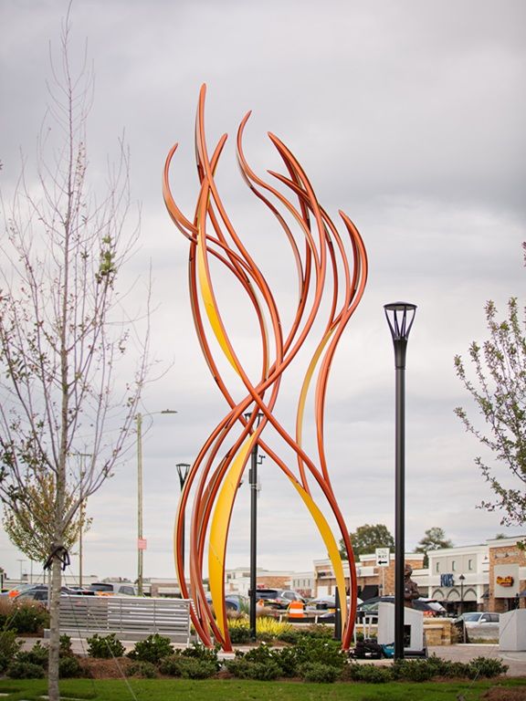 Full image of curved steel sculpture "Be the Light" by Curtis Pittman